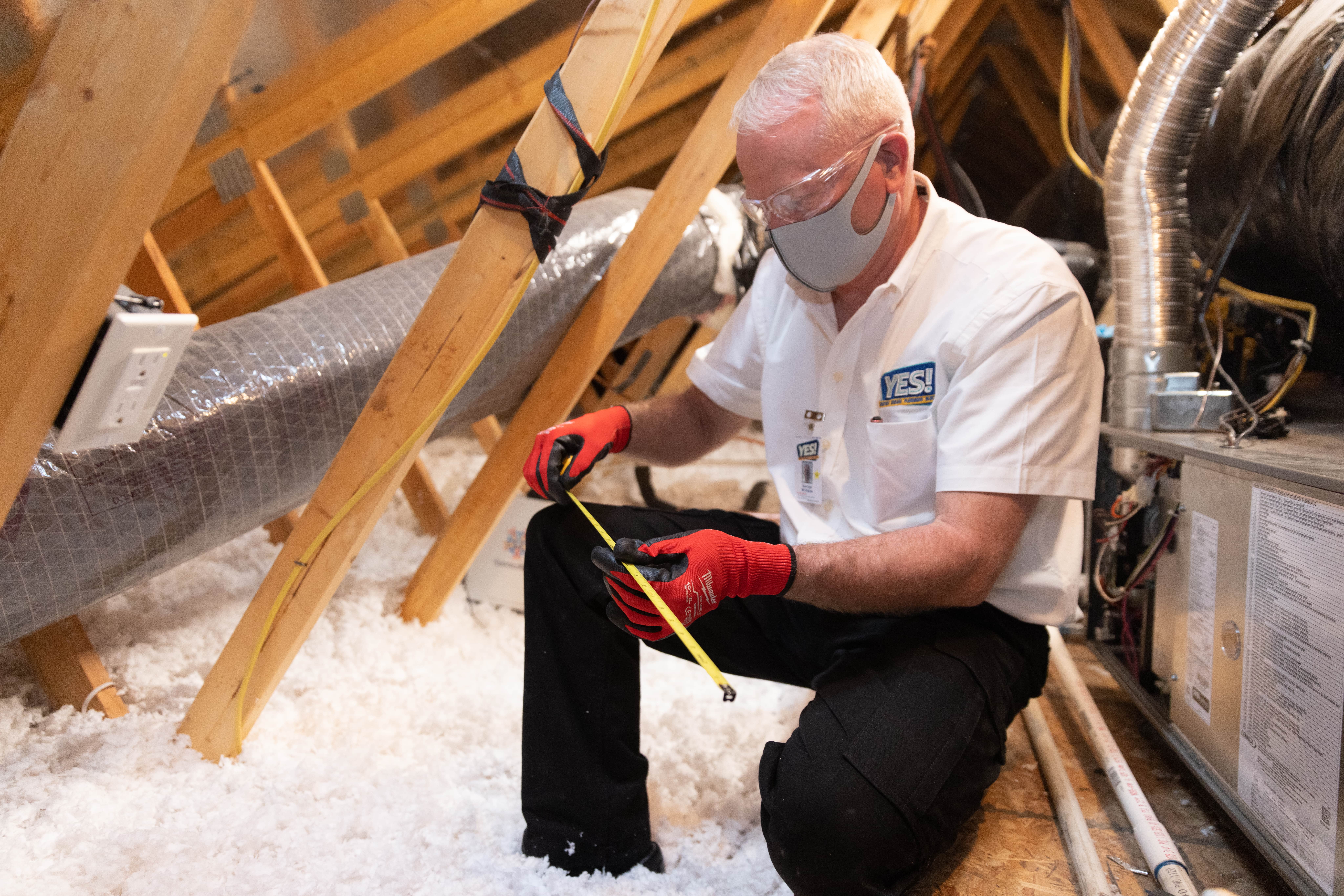 attic insulation installer measuring r-value
