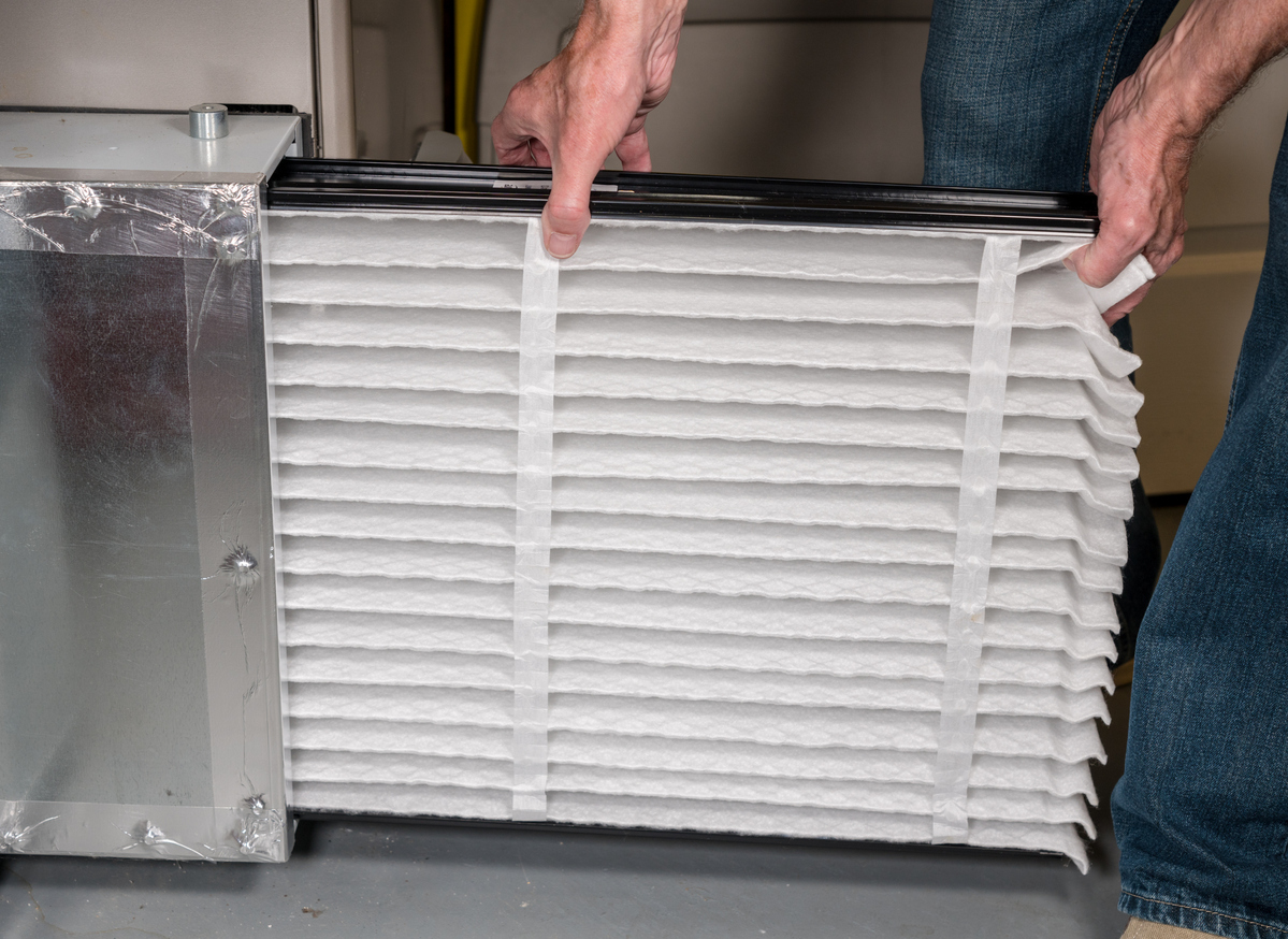 Close-up of a YES! technician installing a filter for an air filtration system at a home in Salt Lake City, UT.